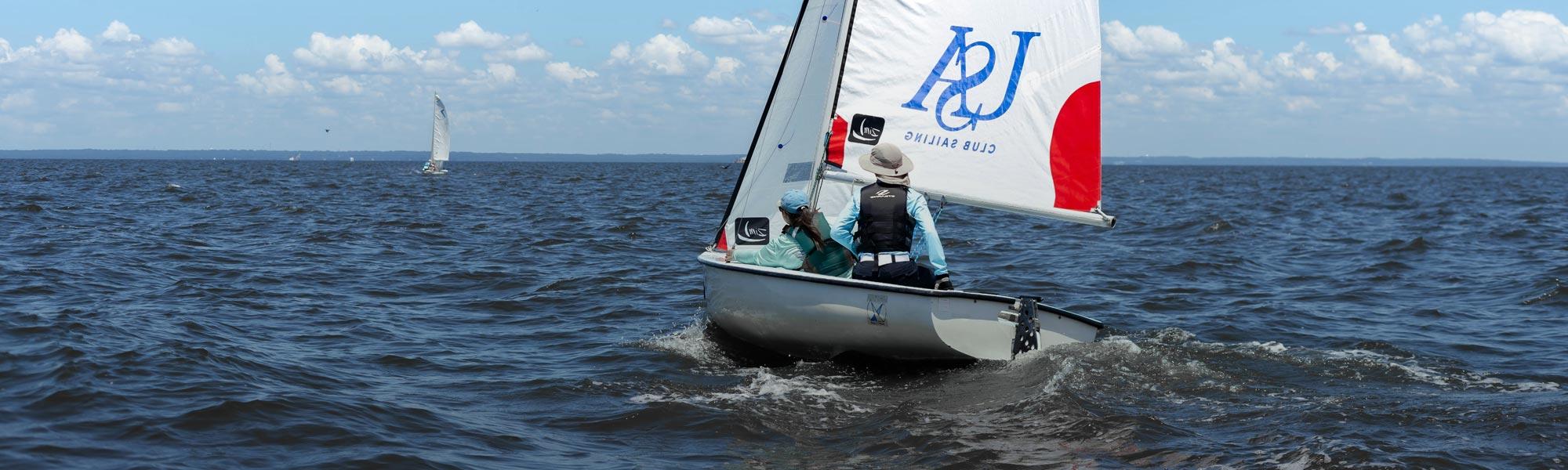 sailing club in a USA branded sailboat on Mobile Bay